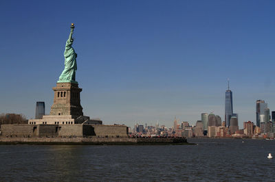 Statue of liberty with city in background