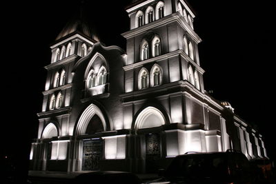 Low angle view of illuminated cathedral against sky at night