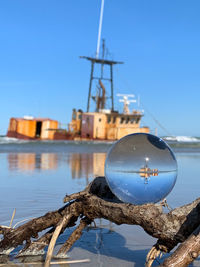 Container ship in lake against clear blue sky