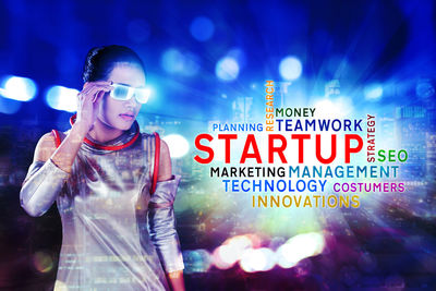 Digital composite image of man using smart phone at night