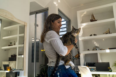 Woman with cat at home