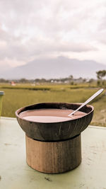 Close-up of bowl on table against sky