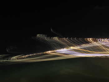 Illuminated city against sky at night