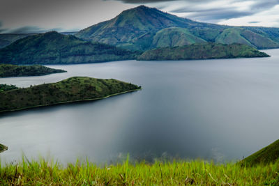 Scenic view of lake and mountains against sky