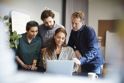 Creative professionals using laptop at office