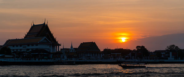 Scenic view of buildings against sky during sunset