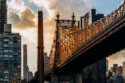 Buildings in city against cloudy sky