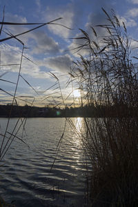 Scenic view of lake against sky at sunset