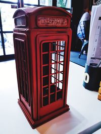 Close-up of telephone booth on table