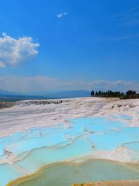Terrace formations at pamukkale against sky