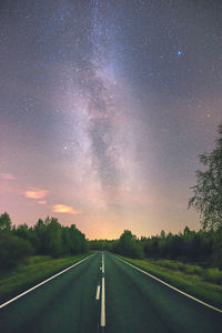 Empty road against sky at night