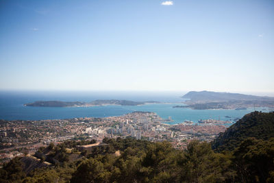 High angle view of townscape by sea against sky