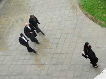 High angle view of people walking on footpath