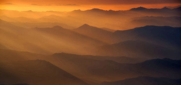 Scenic view of mountains against sky during sunset