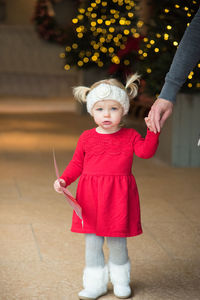 Portrait of cute girl standing on walkway