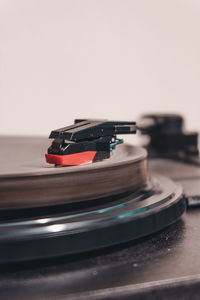 Close-up of record player needle against wall