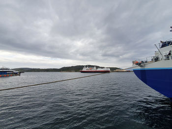 Boats sailing in sea against sky