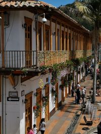 People on street amidst buildings in city