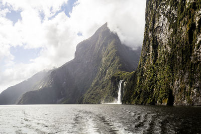 Scenic view of waterfall against sky