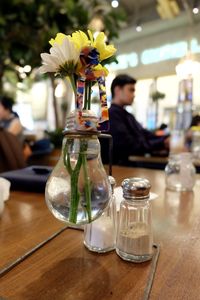 Close-up of flower vase on table in restaurant