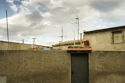 Buildings against cloudy sky