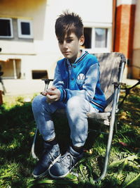 Boy sitting on chair
