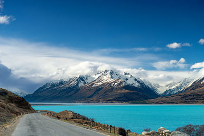 Mount cook road alongside lake pukaki with snow capped southern alps in winter evening light. 