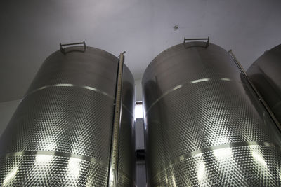 Low angle view of illuminated lighting equipment in building