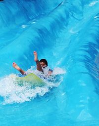 Boy on water slide