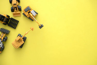 High angle view of toy car on yellow wall