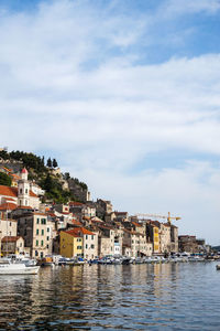 Townscape by sea against sky