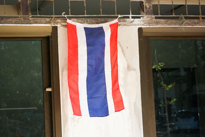 Low angle view of flags hanging against wall