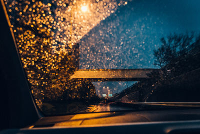 Illuminated road seen through car window