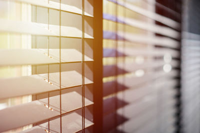 Close-up of piano seen through window