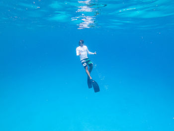 Low section of woman swimming in sea