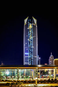 Illuminated buildings against sky at night