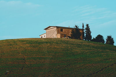 Low angle view of house on field against sky