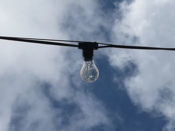 Low angle view of light bulb against sky