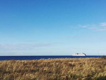 Scenic view of sea against blue sky