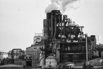 Low angle view of industrial building against sky