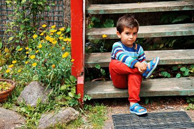 Full length of a boy sitting outdoors