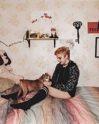 Young woman sitting on sofa at home