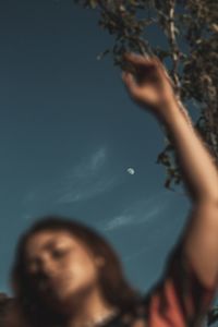 Low angle view portrait of woman against sky