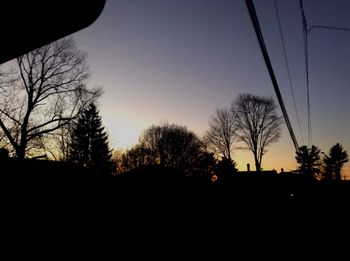 Low angle view of bare trees against sky