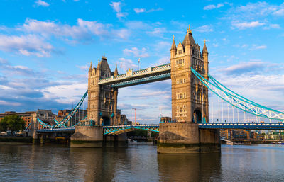 View of bridge over river against cloudy sky