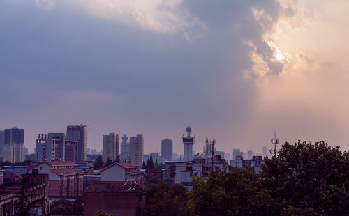 Buildings against cloudy sky