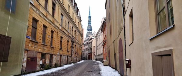 Narrow street amidst buildings in city