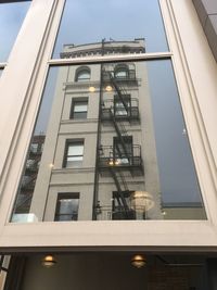 Low angle view of apartment building against sky
