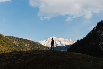 Man standing on mountain against sky