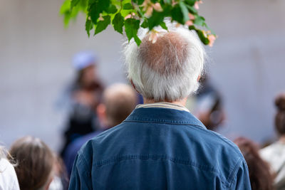 Rear view of man and woman with umbrella